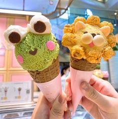 two ice cream cones with animals on them, one is green and the other is yellow