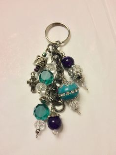 a close up of a key chain with charms on it's end and beads hanging off the side