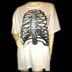 Old Navy New, Never Used/Washed, Mens White T-Shirt Graphic Tee With Black Halloween Human Rib Skeleton Graphic Print - Mens Graphic Tee Shirts. 100% Cotton. Size Xxl. Bust (Pit-Pit) 24-1/2" Across, Length (Shoulder To Hem) 31", Shoulder Width (Back Shoulder-Shoulder) 20-1/2" Across. Mens T-Shirts As Casual Wear, Halloween Attire, Everyday Clothes/Clothing. Seller Code: Prebx-01 Alternative White Tops For Halloween, White Alternative Tops For Halloween, Alternative White Halloween Top, Alternative White T-shirt With Skull Print, White Skull Print Alternative T-shirt, White Cotton Punk Shirt, Punk Style White Cotton Shirt, Alternative White Cotton T-shirt, White Grunge T-shirt With Skull Design