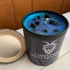 an ice cream container with blue and black toppings