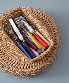 a wicker basket with utensils in it