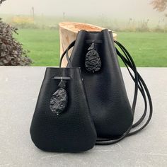 "Vegan Eco Leather Medicine Bag, Shaman Bag or Amulet Pouch to wear around your neck-or hang in your Car, keep on your Altar. Perfect for Ceremony or for Festival Wear. Black Faux Leather with Black Tourmaline Nuggets. Unique and Beautiful Gift . A place for things that have Spiritual Meaning for you-like that pretty rock your 3 year old gave you.... Two Choices: Small:3 3/4\"deep 2 3/4\"wide Large:5 1/4\"deep 4\"wide BUY ANY 4 MEDICINE BAGS(VEGAN LEATHER )AND GET 10 % OFF! USE COUPON: 4MP10 .OR Black Pouch Coin Purse, Black Portable Pouch Coin Purse, Portable Black Pouch For Everyday Use, Portable Black Pouch Coin Purse, Handmade Black Bag As A Gift, Handmade Black Bag As Gift, Handmade Black Bag For Gift, Portable Pouch Shoulder Bag As Gift, Black Mobile Phone Bag As Gift