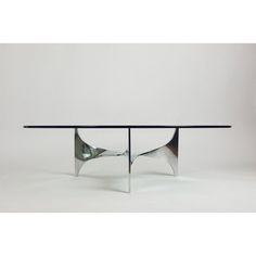 a glass table with two metal legs and a black top, on a white background