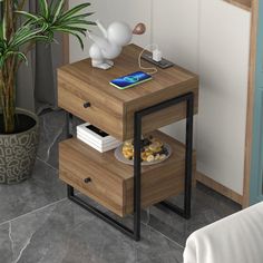 a small table with a phone on it next to a potted plant