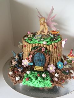 a cake decorated to look like a fairy house