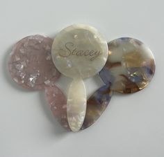 three pieces of glass with the word spacey written on one side and two different colored stones in the other