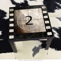 a black and white table with a number 2 on it in the middle of a rug