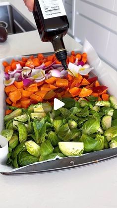 a person is using an electronic device to check the vegetables in a tray on a counter