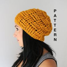 a woman wearing a yellow knitted hat with the words pattern on it in front of her face