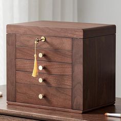 a wooden jewelry box sitting on top of a table