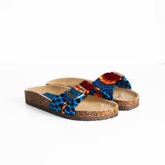 Wax slides / Blue disc wax / Women's shoes / Buckled slides / Blue sandals / Wax print shoes / African fabric This pair of buckled sandals is decorated with a wax disc print with a blue, orange and brown pattern. Sole height: 1.5 cm Straps: faux leather and wax fabric Wax color: blue, orange, brown Insole: faux leather Outsole: faux leather NON-EXCHANGEABLE AND NON-REFUNDABLE ITEM Blue Slip-on Slides For Vacation, Blue Sandals With Cork-bed Midsoles For The Beach, Blue Fabric Sandals With Round Toe, Blue Fabric Round Toe Sandals, Blue Adjustable Slides For Vacation, Blue Open Toe Slides With Cork-bed Midsoles, Blue Fabric Open Toe Sandals, Casual Blue Fabric Sandals, Blue Disc