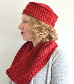 a woman wearing a red crocheted hat and scarf