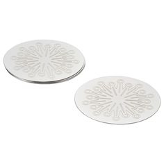 two white coasters sitting on top of each other