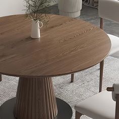 a round wooden table with white chairs around it and a plant in a vase on top