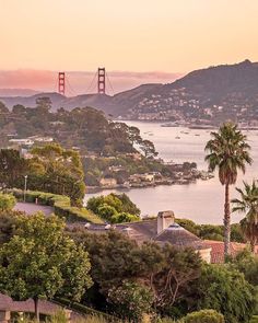 the golden gate bridge in san francisco, california is seen from across the bay at sunset