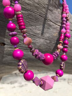 This necklace is a mix of wood,metal, sparkle and magic. This magenta will stand out so will the sweet elephant stamped brass bead. There's so much to look at that you'll dazzle when you walk-in a room wearing this one-of-kind necklace. It is great for layering or it will stand alone. It's lightweight and comfortable for easy all day wear. Polymer, wood, metal, dyed jade and even vintage resin beads made this an eclectic party round your neck.  My creations are never repeated and always unique, Bohemian Purple Necklace With Wooden Beads, Pink Bohemian Multi-strand Necklaces, Bohemian Multi-strand Pink Necklace, Eclectic Party, Sweet Elephant, Multilayer Necklace, Double Strand Necklace, Multi Layer Necklace, Textile Jewelry