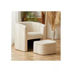 a white chair and ottoman in a room