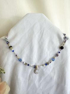 16.5 in. beaded necklace with moon pendant. Diy Moon Necklace, Light Blue Bead Necklace Mushroom, Moon Beaded Necklace, Celestial Blue Beaded Necklaces, Celestial Blue Beaded Jewelry, Bohemian Necklaces With Moon Charm And Round Beads, Gift Beaded Necklaces With Moon Charm And Round Beads, Handmade Blue Moon-shaped Necklaces, Handmade Blue Moon Necklaces