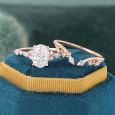 a close up of a ring on top of a blue velvet cushion with gold trim