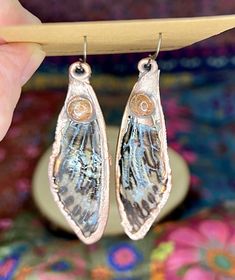 These genuine, ethically-sourced, cicada wings have been sealed in resin, then electroformed with a thick plate of copper. A sunstone cabochon adorns each earring, which hangs from a brass earwire. Nature-inspired Electroformed Brass Earrings, Earthy Soldered Earrings For Gift, Adjustable Electroformed Bronze Earrings, Bronze Copper Spiritual Earrings, Spiritual Bronze Copper Earrings, Brown Electroformed Teardrop Jewelry, Brown Electroformed Brass Earrings, Cicada Wings, Insect Wings