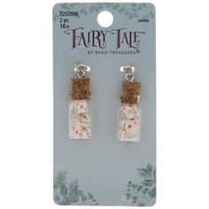 the fairy tale earrings are made with cork and fabric, which is decorated with pink flowers