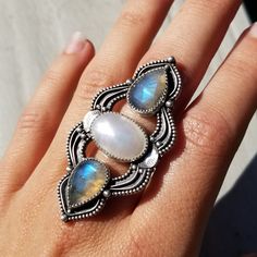 This one-of-a-kind statement ring measures just over 2 inches and features an oval baroque pearl cabochon with teardrop labradorites and decorative beading and details. Finished with a solid ring shank, everything is handcrafted from sterling silver. Pearl symbolizes wisdom gained through experience. It will help you learn the lessons from every life experience, and it will make you wiser and stronger for it. It's also a stone that will offer protection and security. You can go about doing your Heirloom Silver Teardrop Jewelry, Unique White Multi-stone Moonstone Ring, Heirloom Teardrop Gemstone Jewelry, Heirloom Silver Jewelry With Gemstone Accents, Handcrafted Oval Moonstone Ring, Handmade Artisan Oval Moonstone Ring, Bohemian Silver Moonstone Ring With Gemstone Accents, Silver Bohemian Moonstone Ring With Gemstone Accents, Silver Teardrop Cabochon Rings