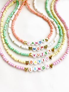 "Welcome to our vibrant and joyful personalized name necklace collection! Our colorful necklaces are perfect for children and make for a wonderful kids' birthday gift, designed to bring smiles to their faces. With six stunning color options to choose from, each necklace is a unique masterpiece. Crafted with colorful beads and adorned with Mother of Pearl letters that spell out a custom name, these necklaces are truly one of a kind. Make your little one's day special by gifting them a personalized name necklace that reflects their unique personality and style. Whether it's for a birthday, a special occasion, or just to show your love, these necklaces are sure to be cherished keepsakes.\" HOW TO ORDER ? 1- Choose the letter quantity of the name/word/phrase/initials you want. 2- Find the righ Handmade White Charm Necklaces For Birthday Gift, Trendy Personalized Charm Necklaces For Birthday, Trendy Personalized Charm Necklace For Birthday, Trendy Customizable Charm Necklaces As Gift, Trendy Personalized Charm Necklace As Gift, Trendy Customizable Charm Necklaces For Gifts, Trendy Personalized Charm Necklace For Gifts, Personalized Trendy Charm Necklaces As Gifts, Personalized Trendy Charm Necklaces For Gifts