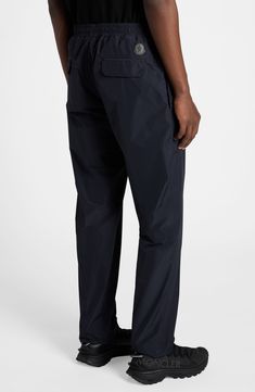 Elevate your casual look with these athleisure-inspired pants crafted from microventile léger, a high-performance fabric notable for its water-repellent properties. Elastic/drawstring waist Side-seam pockets; back flap pockets 100% polyester Machine wash, line dry Imported Designer Clothing Nylon Long Pants With Functional Drawstring, Travel Pants With Side Pockets And 4-way Stretch, 4-way Stretch Travel Pants With Side Pockets, Sportswear Bottoms With Functional Pockets And 4-way Stretch, Nylon Bottoms With Pockets For Travel, Travel Bottoms With Elastic Waistband And Nylon Material, Outdoor Nylon Tapered Leg Pants, Navy Nylon Bottoms For Outdoor, Athleisure Nylon Bottoms With Functional Pockets