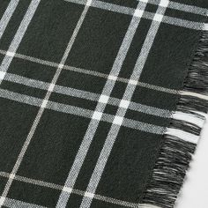 a black and white plaid blanket with fringes