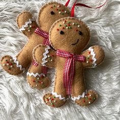 two brown teddy bears with red and white bows