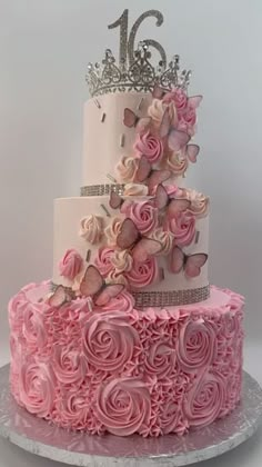 a three tiered cake with pink frosting roses and butterflies on the top layer