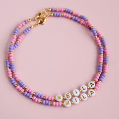 Personalised beaded necklace.  Special gift, customised Just for You! Handmade with love using matt glass seed beads in pink and purple colours, 7mm gold letter beads and 14k gold plated accent beads with gold plated lobster clasps.  Can be made in different sizes. Necklace should not come into contact with water, chemicals or perfume.Please also take off while showering or swimming. Handmade with love. Adjustable Gold Beaded Necklace With Letter Beads, Gold Round Bead Necklaces For Friendship, Purple Beaded Necklace With Letter Beads As Gift, Gold Beaded Necklaces With Letter And Round Beads, Gold Beaded Necklaces With Letter Beads, Pink Heishi Beads Necklace For Gift, Pink Letter Beads Necklace For Birthday, Pink Beaded Necklace With Gold Beads As Gift, Pink Beaded Necklace With Gold Beads For Gift