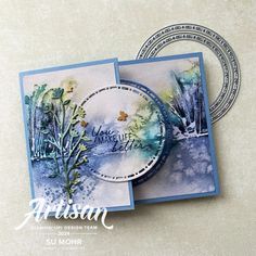 a card with watercolor trees on it and the words artisan written in white