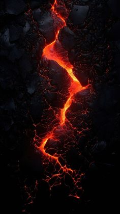 lava flowing down the side of a mountain with red and orange flames coming out of it