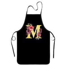 a black apron with flowers and the letter m on it