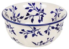 a blue and white bowl with leaves on it