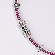 This retro style choker necklace is made from 18-karat white gold. The necklace features a total of 17.30 carats of baguette-cut rubies, complementing the rubies are 0.44 carats of diamonds. The necklace measures 16 inches in length and 8mm in width, and weighs 35.67 grams.   Details:  Item Type: Choker Necklace Metal: 18K White Gold Weight: 35.67 Grams  Length: 16 inches Width: 8mm Setting: Channel Style: Retro  Stone Details: Gemstone: Ruby Carat: 17.30  Cut: Baguette Color: Red  Secondary Stone Details: Gemstone: Diamond Carat: 0.44 Cut: Round Color: White Luxury Red Baguette Diamond Jewelry, Diamond Carat, Baguette Cut, 3 Carat, Metal Necklaces, Style Retro, Retro Style, Retro Fashion, Choker Necklace