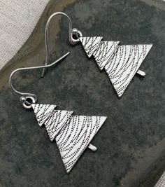 "These are perfectly festive and exquisitely detailed silver Christmas tree earrings. They are understated and classy. The perfect go to holiday earrings. These would make a very festive gift for a friend, loved one or secret Santa. The trees measure 1\" long by 3/4\" wide. They hang from simple silver ear wire hooks. Overall drop length is 1 1/8\". Made from allergy free plated silver. I have a matching necklace in my shop if you would like the whole set. Here is a direct linkhttps://etsy.me/32 Christmas Silver Jewelry With Matching Earrings, Christmas Anniversary Jewelry With Matching Earrings, Silver Jewelry With Matching Earrings For Christmas, Matching Earrings Jewelry For Christmas Anniversary, Nickel Free Sterling Silver Christmas Jewelry, Nickel Free Silver Earrings For Christmas, Nickel-free Silver Earrings For Christmas, Holiday Silver Jewelry With Ear Wire, Elegant Silver Christmas Earrings