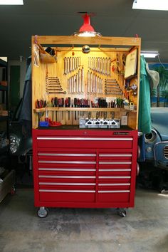 a red tool cabinet with many tools in it