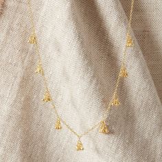 A really pretty handmade jangly gold necklace with Sterling Silver and 18 carat gold. Handmade ball charms clustered and dangling in trios, and hanging all along the chain.  Great for adding an extra layer with a more textured look, to your existing chains. Feminine and elegant to wear on its own, and for anyone who loves a flattering, understated and minimalist charm style necklace. Handmade using 18K Gold and Sterling Silver, I never use inferior metals in any of my designs. This necklace meas Bohemian Dangle Charm Necklace With Clavicle Chain, Bohemian Charm Necklace With Clavicle Chain, Elegant Brass Necklaces With Dangling Charms, Elegant Brass Necklace With Dangling Charms, Dainty Yellow Gold Dangle Charm Necklaces, Dainty Yellow Gold Brass Charm Necklace, Bohemian Dangle Chain Necklace With Delicate Chain, Bohemian Dangle Delicate Chain Necklace, Delicate Dangle Charm Necklaces