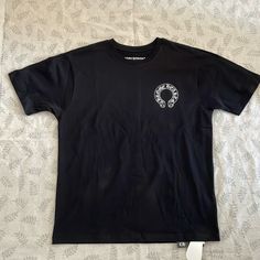 Chrome Hearts Casual Black Cotton White Logo Printed T-Shirt Color: Black Size:Xl 100% Cotton, Brand New With Tags. Black Graphic Tee With Short Sleeves, Black Short Sleeve Graphic Tee, Black Short Sleeve Top With Screen Print, Black Print Short Sleeve Tops For Streetwear, Black Short Sleeve T-shirt With Back Print, Black Tops With Heart Graphic And Short Sleeves, Black Short Sleeve Top With Heart Graphic, Black Cotton Top With Heart Graphic, Black Short Sleeve Tops With Back Print