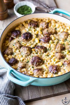 a blue pot filled with pasta and meatballs