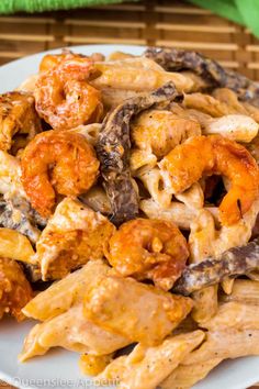 pasta with chicken and mushrooms on a white plate