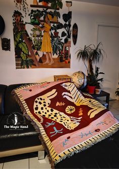 a living room with a couch and paintings on the wall