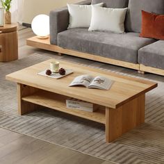 a living room with two couches, a coffee table and a book on it