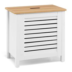 a white cabinet with wooden top and drawers on the bottom, in front of a white background