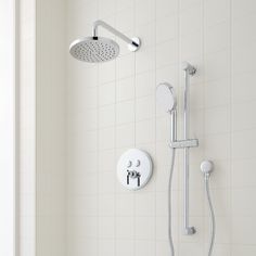 a shower head and hand shower in a white tiled bathroom with thermostaer