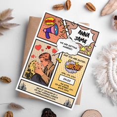 a greeting card with an image of a comic strip and nuts on the table next to it