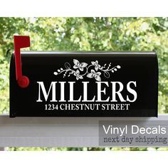 a black mailbox with the name miller's chestnutnut street on it and a red post