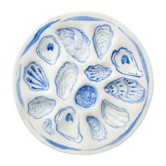 a blue and white plate with seashells on it